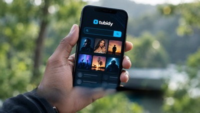 Illustrative Tubidy mobile screen on a phone held outdoors